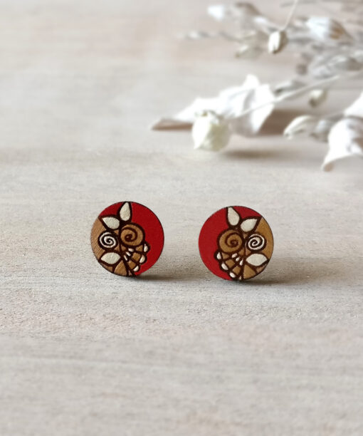 lovely wooden earrings in red color mini round on background