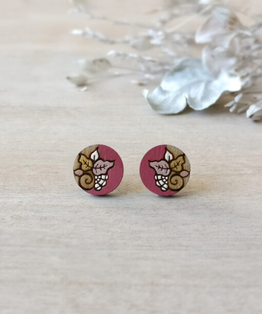 colorful wooden earrings in pink color mini round on background