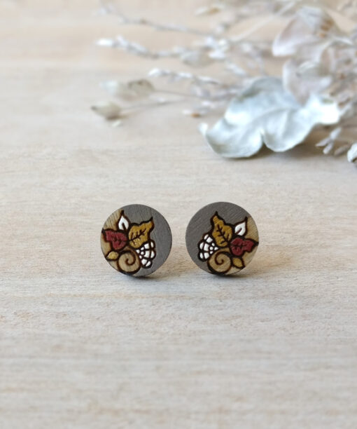 detailed wooden earrings in grey color mini round on background