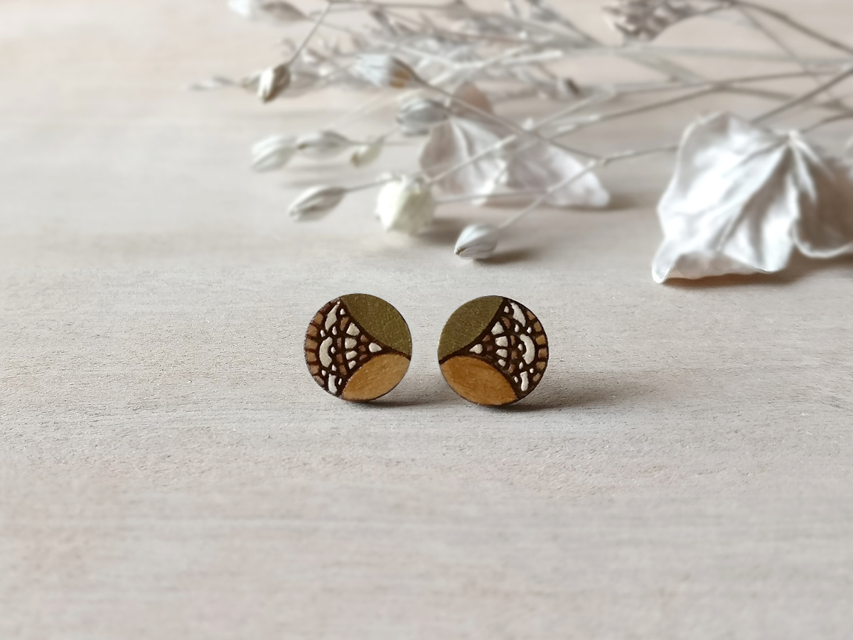 gold wooden earrings mini round on background