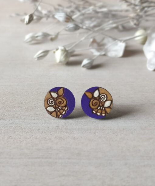 handcrafted wooden studs in purple color mini round on background
