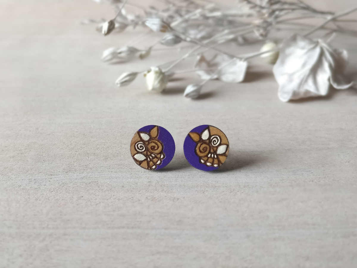 handcrafted wooden studs in purple color mini round on background