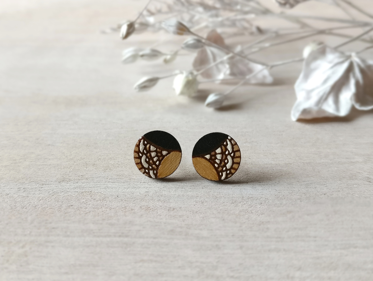 lovely wooden studs in black color mini round on background