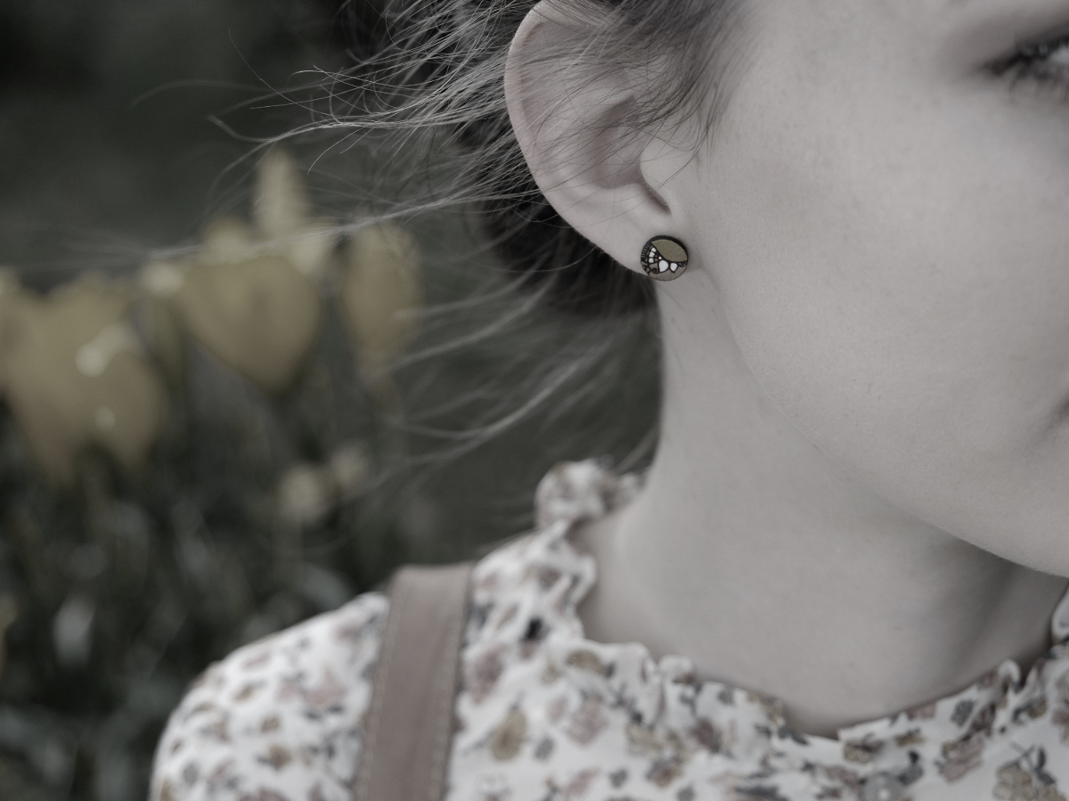 mini round wooden earrings nature design on model