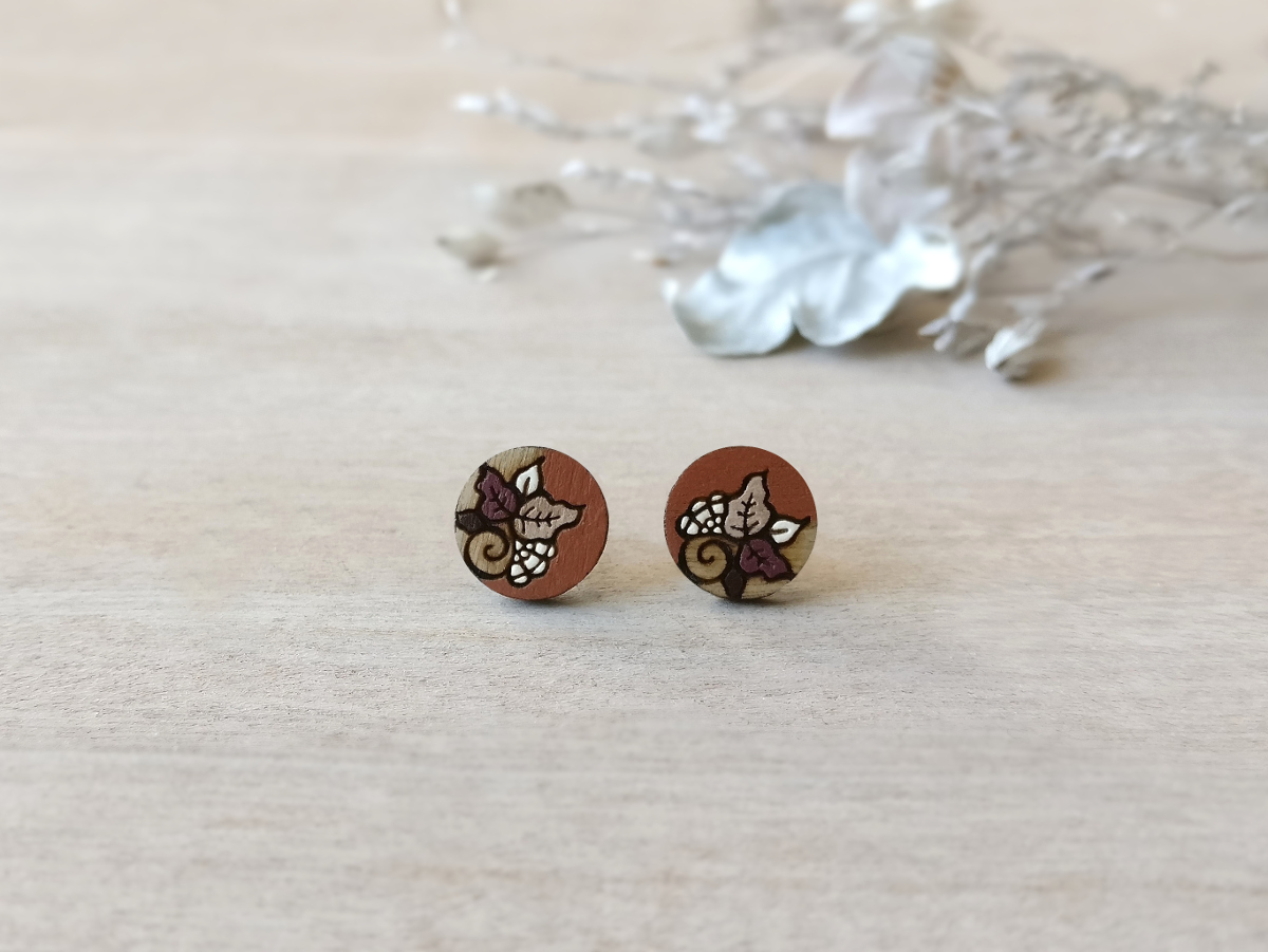 retro wooden earrings in brown color mini round on background