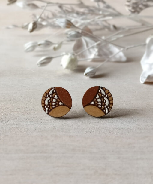 stylish wooden studs in copper color mini round on background
