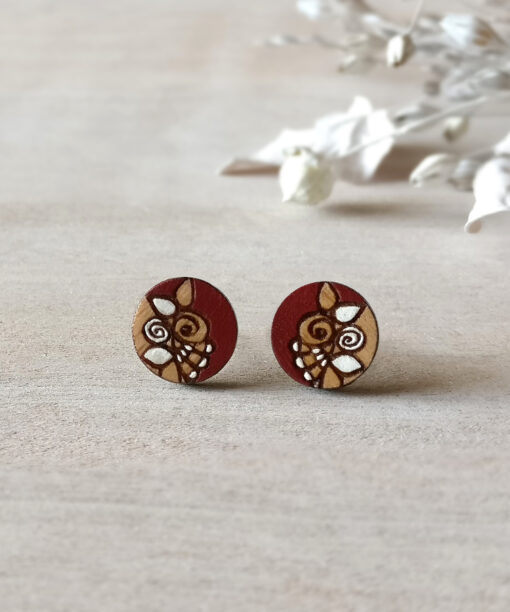 unique wooden earrings in dark red color mini round on background