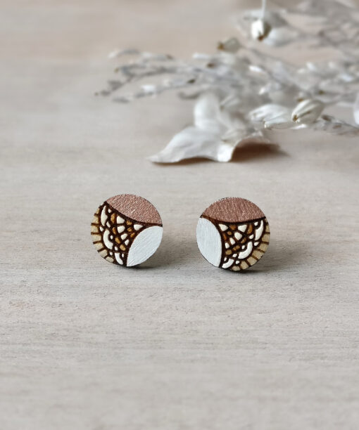 unique wooden studs in rose gold color mini round on background