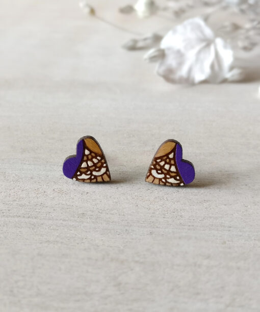 handcrafted wooden heart studs in purple color on background