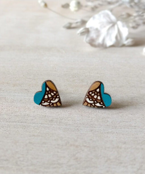 handmade wooden heart earrings in turquoise color on background