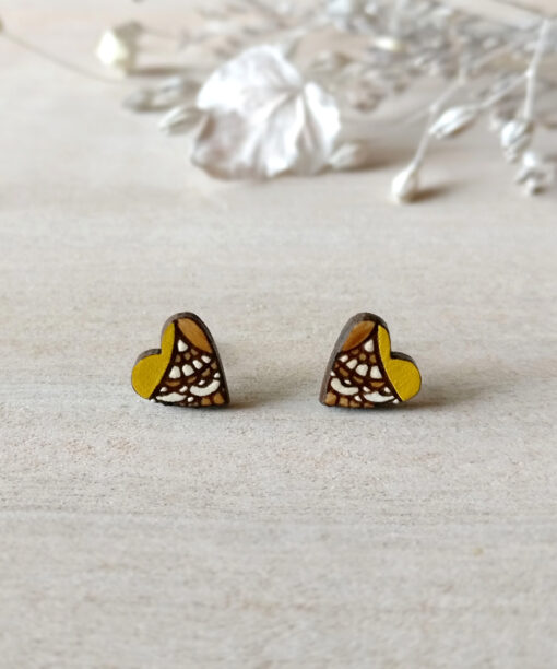 handmade wooden heart studs in yellow color on background