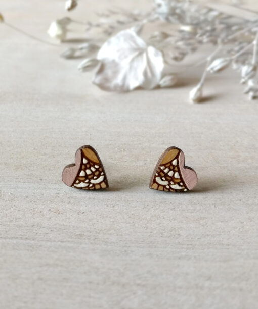 wooden heart studs in light pink color on background