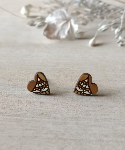 lovely wooden heart studs in copper color on background