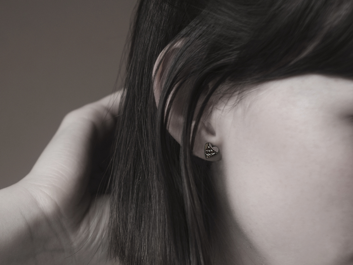 mini heart wooden earrings on model