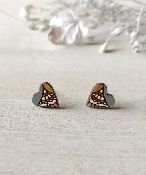 stylish wooden heart earrings in silver color on background