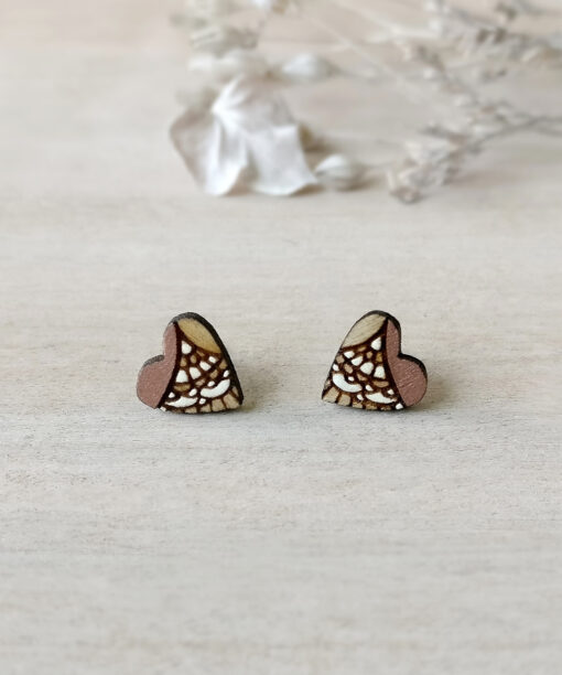 unique wooden heart studs in rose gold color on background