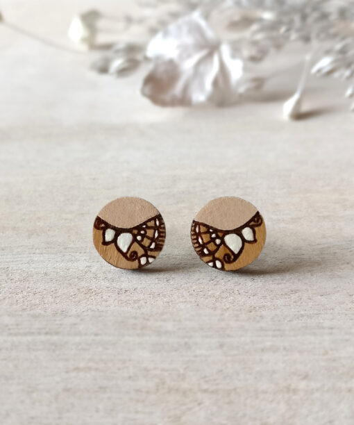 beige wooden earrings mini round on background