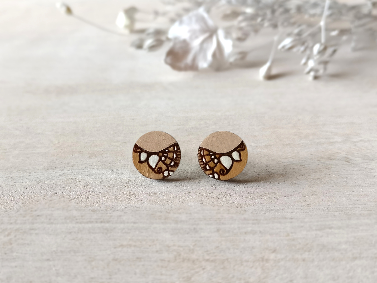 beige wooden earrings mini round on background