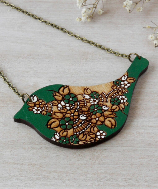 bird green wooden necklace on background