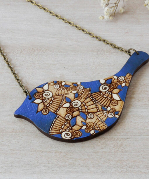 bird royal blue wooden necklace on background