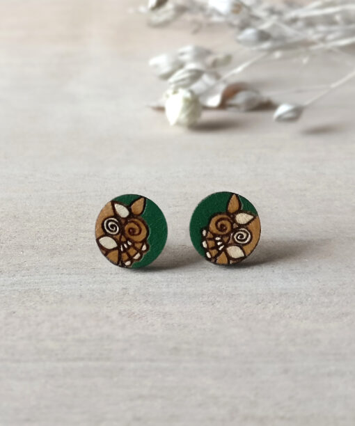 green wooden earrings mini round on background