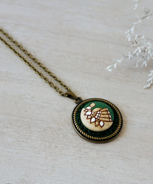 green wooden necklace on background