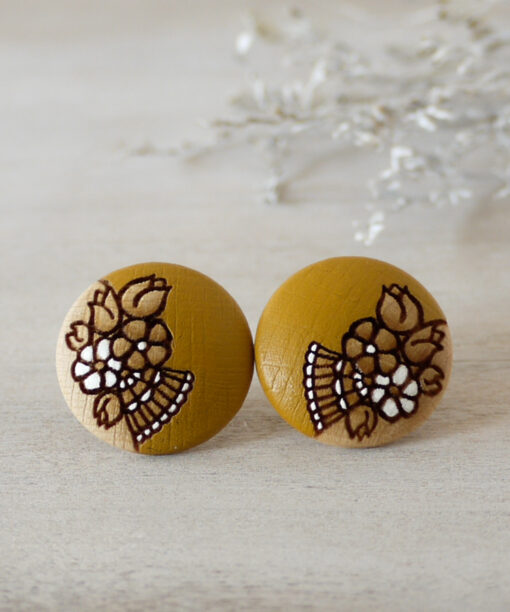 handmade wooden earrings in ochre color large on background