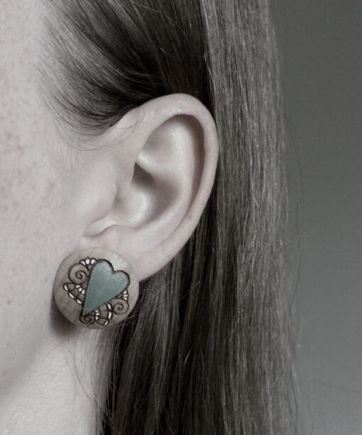 large wooden earrings heart design on model