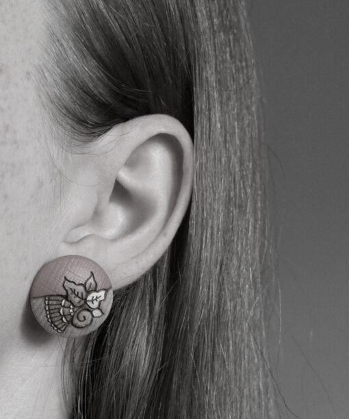 large wooden earrings leaves design on model