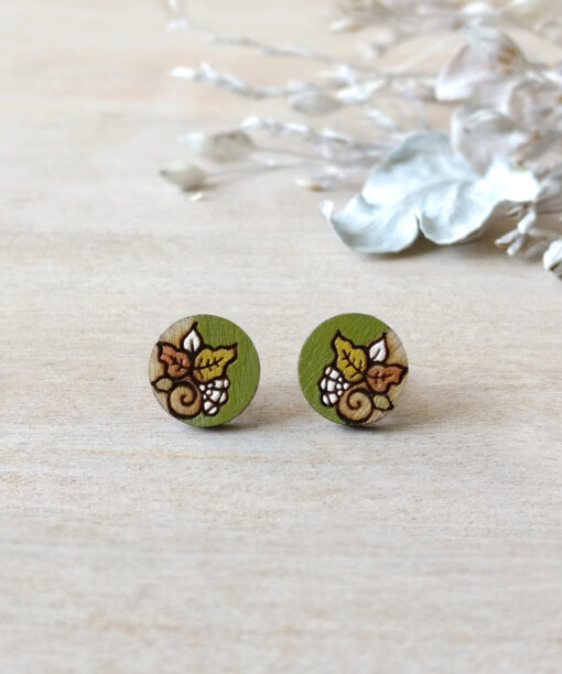 light green wooden earrings mini round on background