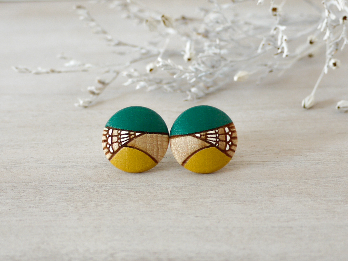 medium green wooden earrings on background