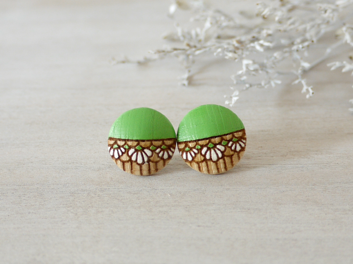 medium handmade wooden earrings green on background