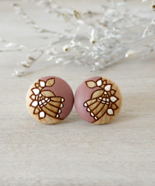 medium light pink wooden earrings on background