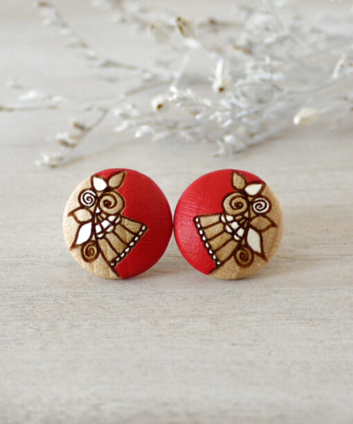 medium red wooden earrings on background