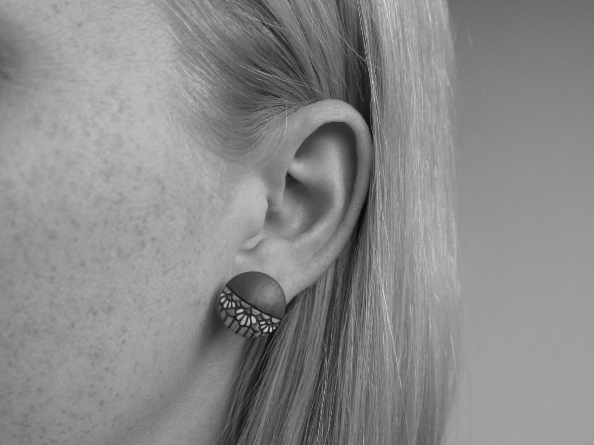 medium wooden earrings daisy design on model