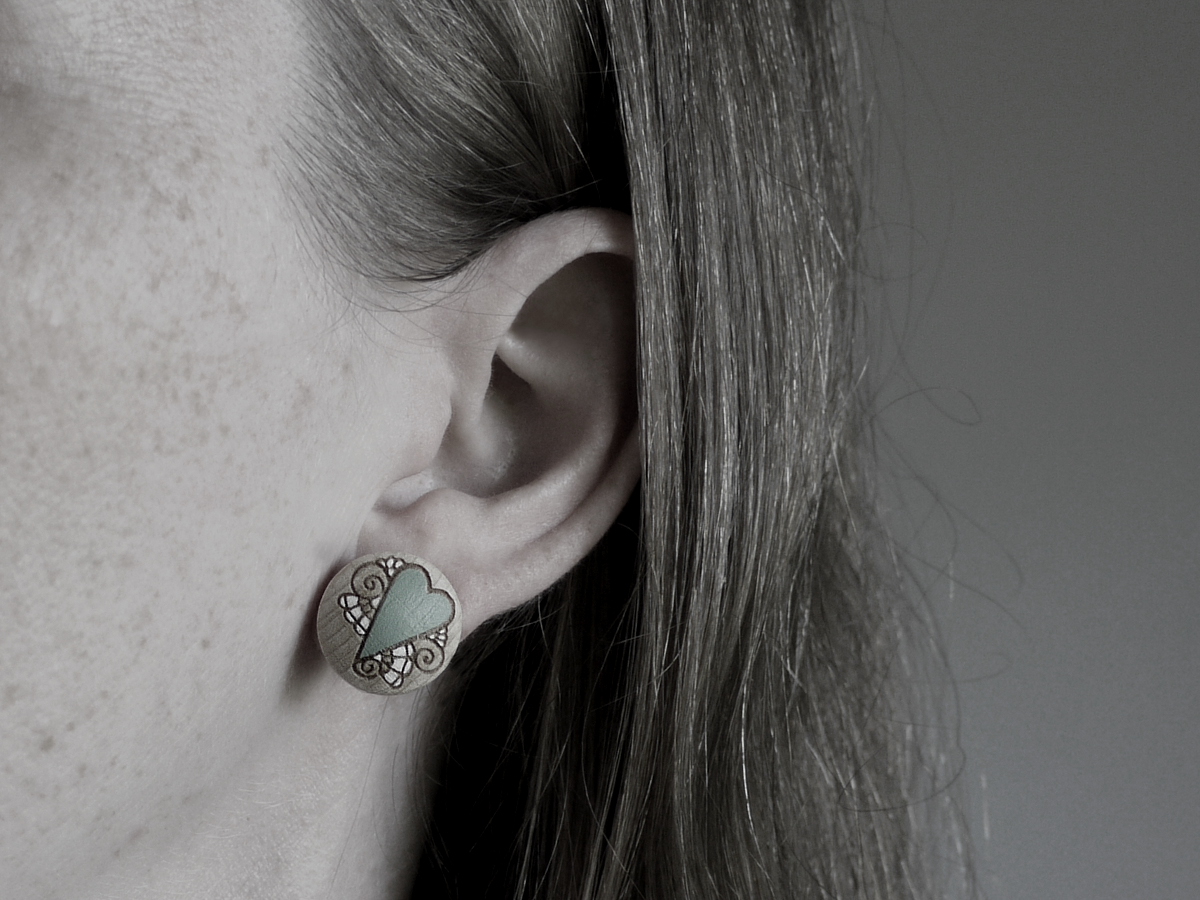 medium wooden earrings heart design on model