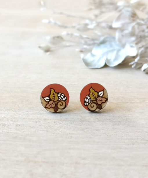 orange wooden earrings mini round on background