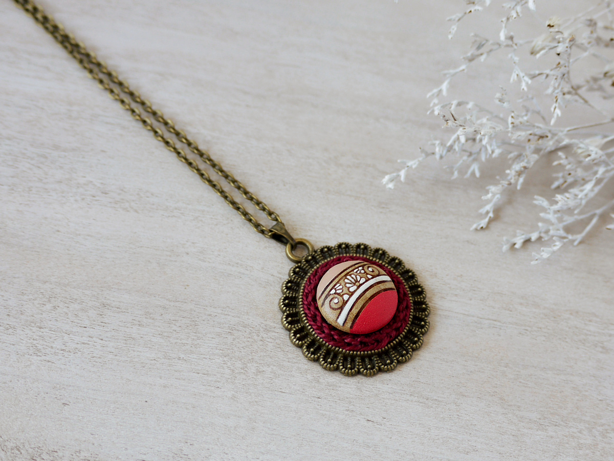 pink wooden necklace on background