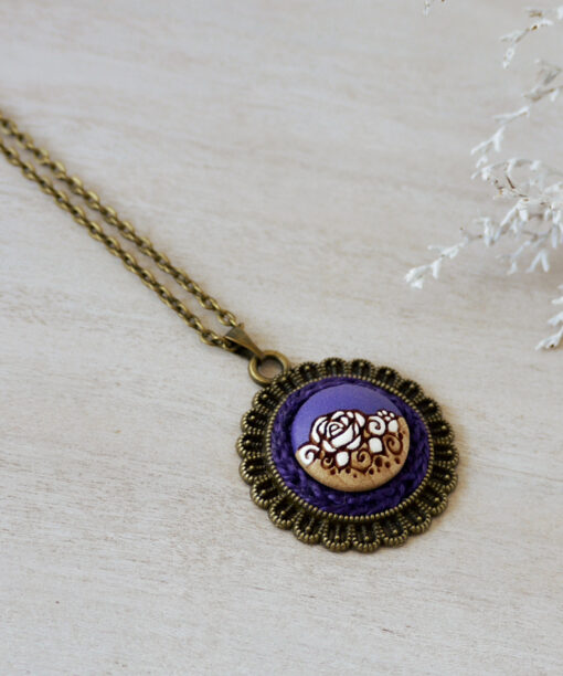 purple wooden necklace on background