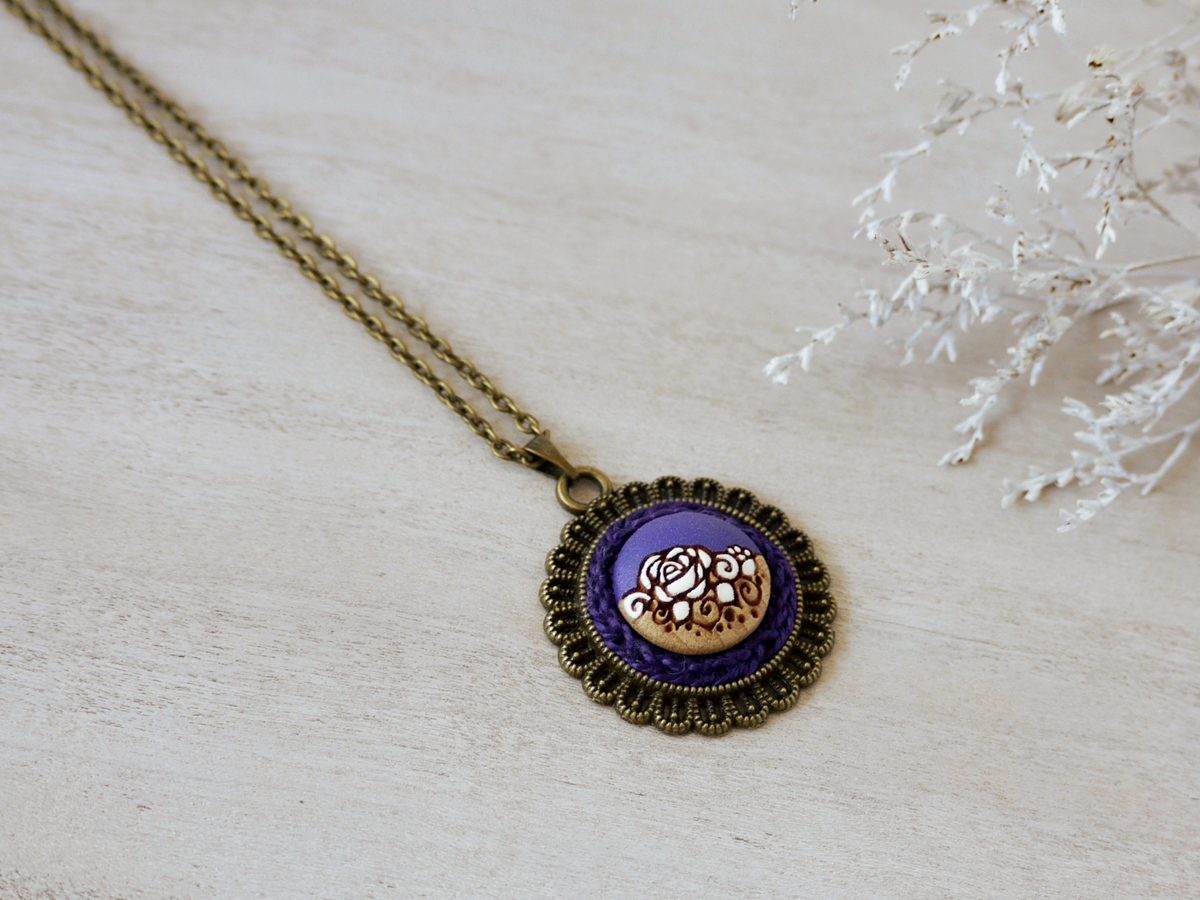 purple wooden necklace on background