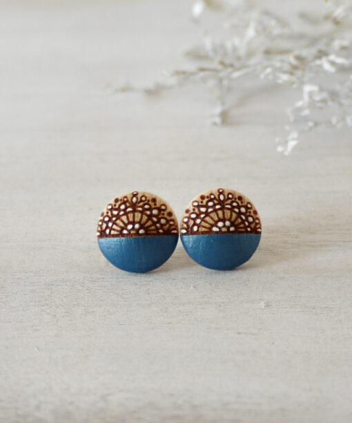 small blue wooden earrings on background