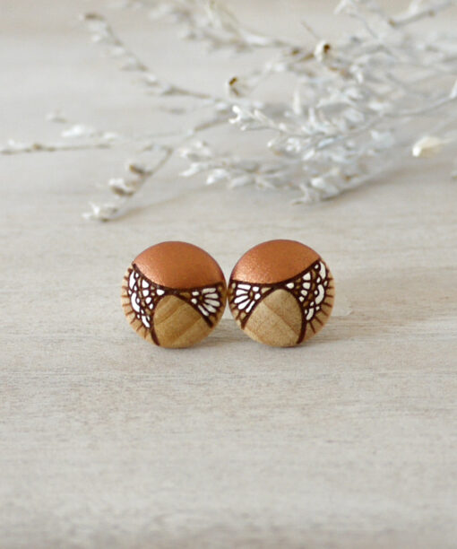 small copper wooden earrings on background