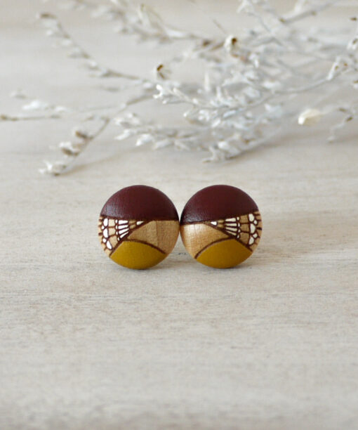 small dark red wooden earrings on background