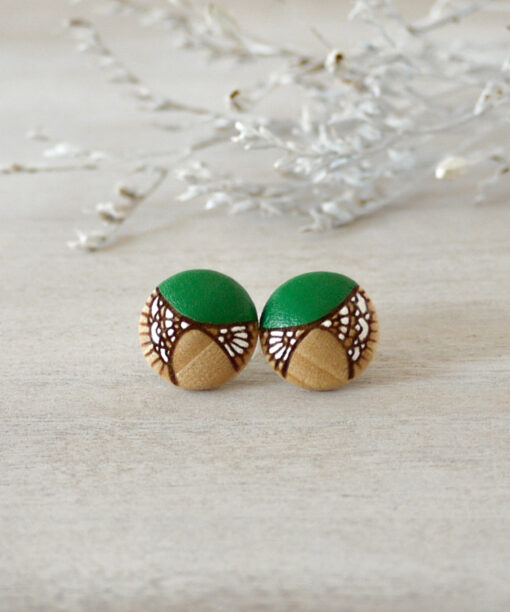 small green wooden earrings on background