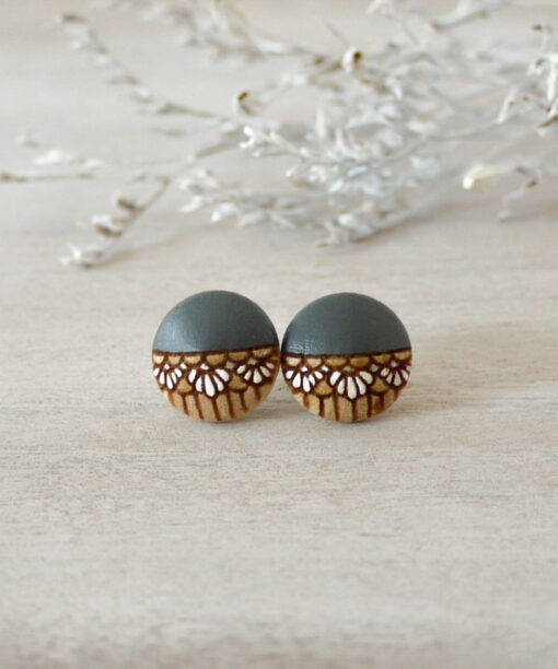 small grey wooden earrings on background