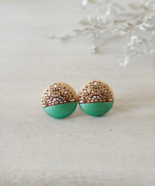 handmade wooden earrings in green color small on background