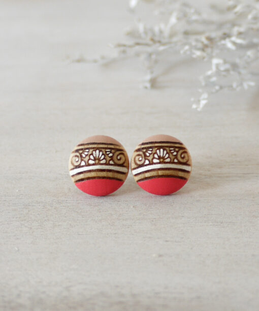 small pink wooden earrings on background