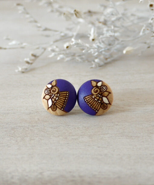small purple wooden earrings on background