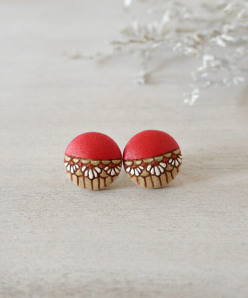 small red wooden earrings on background