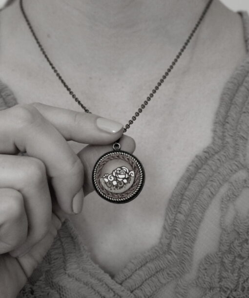 small round wooden necklace rose design on model